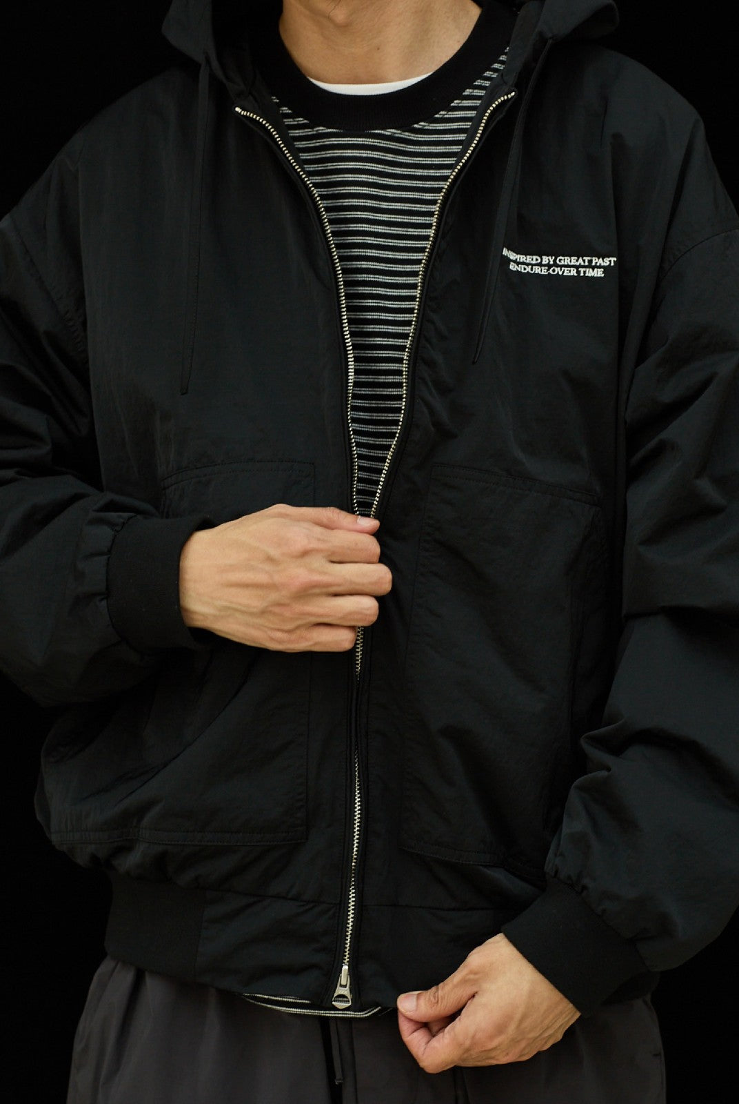 USAGE Crinkle Nylon Hooded Track Jacket in Black - On Male Model