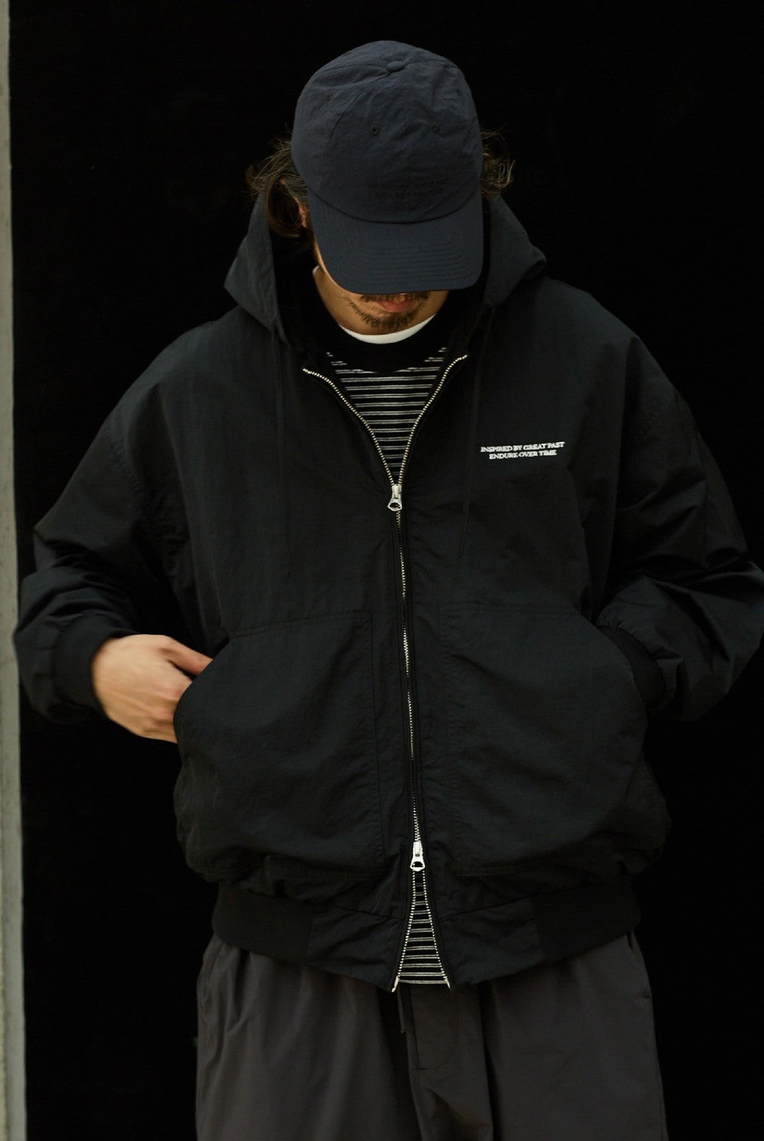 USAGE Crinkle Nylon Hooded Track Jacket in Black - On Male Model