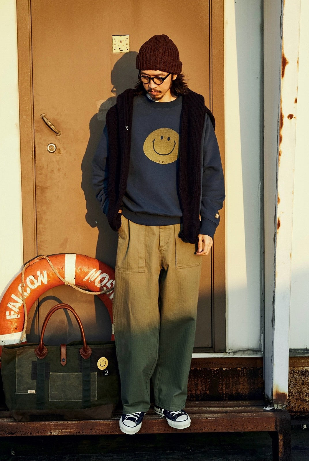 USAGE Washed Cotton Raglan Smiley Sweatshirt in Blue - On Male Model