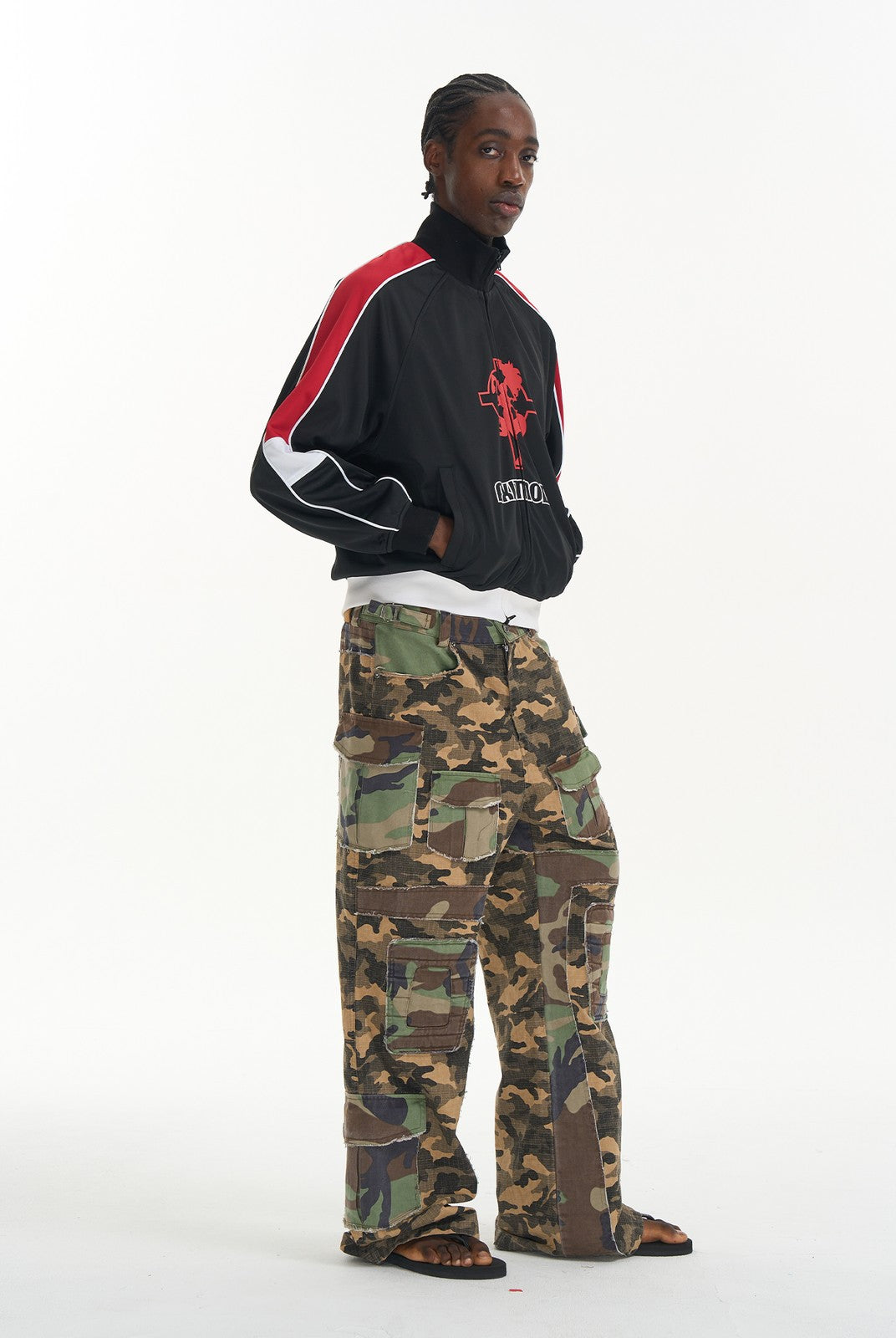 BLINDNOPLAN Paneled Camo Flared Cargo Pants in Green - On Male Model