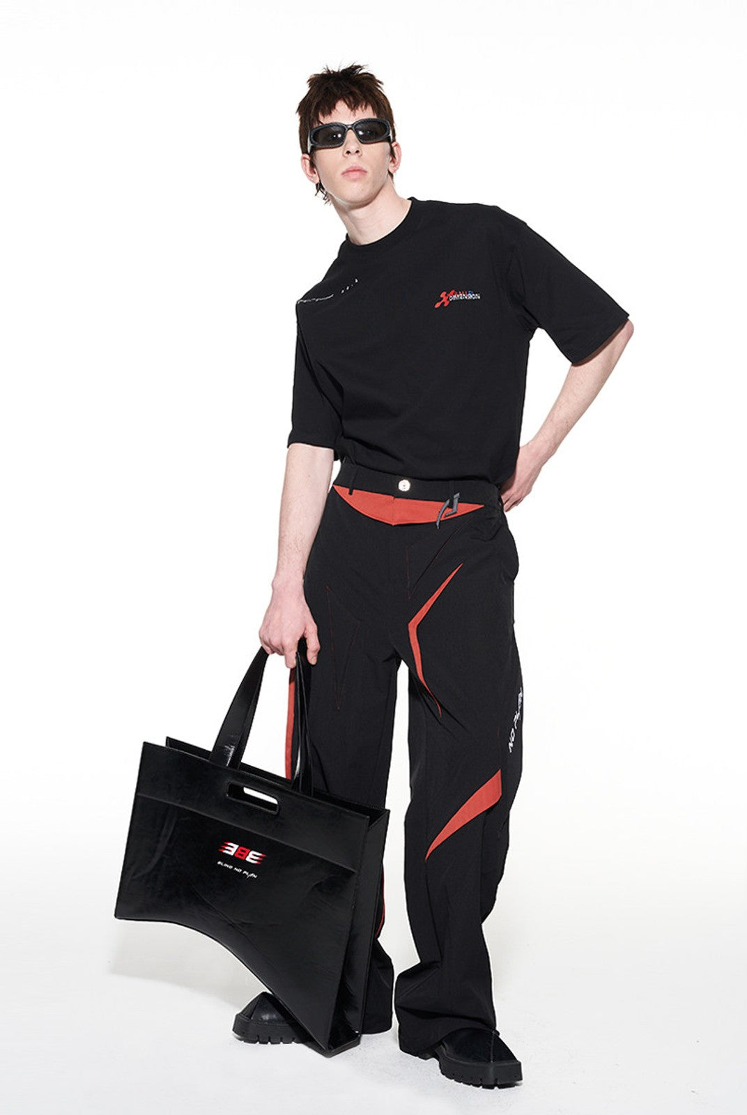 BLINDNOPLAN Textured Faux Leather Asymmetric Tote in Black - On Male Model