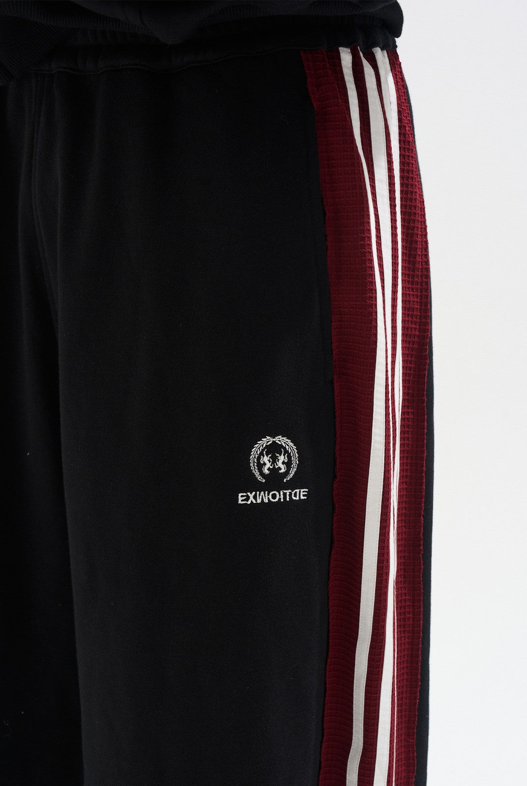 BLINDNOPLAN Raw Edge Contrast Paneled Sweatpants in Black - On Model