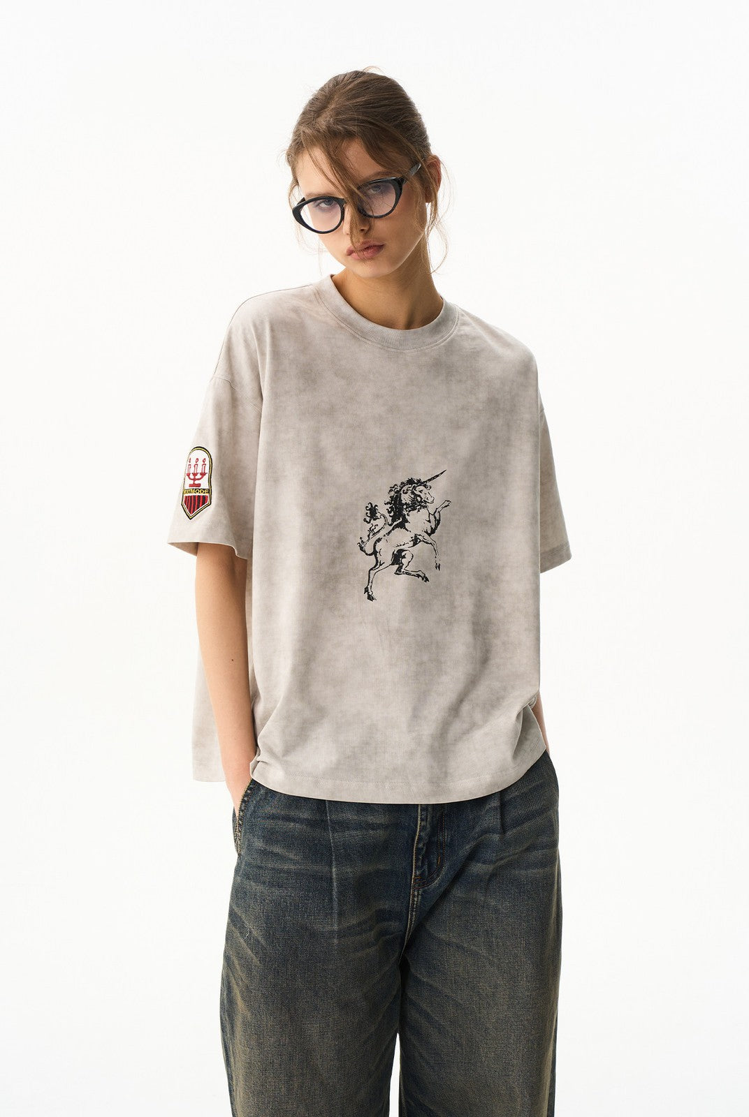 BLINDNOPLAN Wax Print Unicorn Graphic T Shirt in Beige - On Female Model