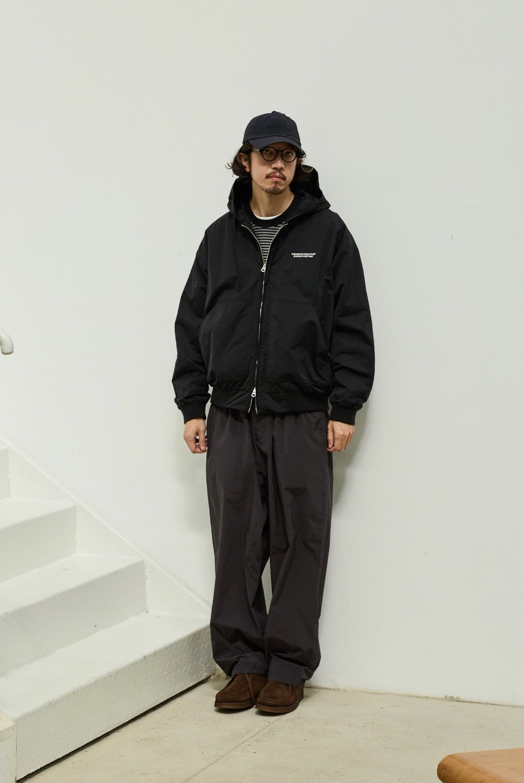 USAGE Crinkle Nylon Hooded Track Jacket in Black - On Male Model