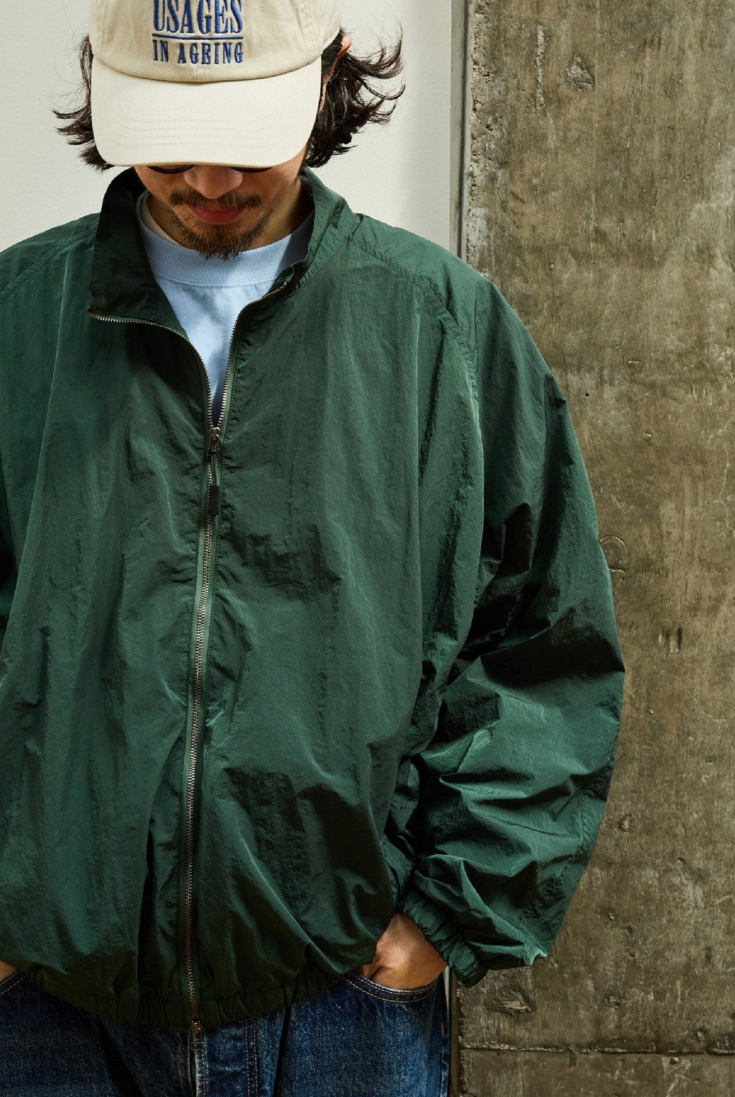 USAGE Lightweight Nylon Zip Up Jacket in Green - On Male Model