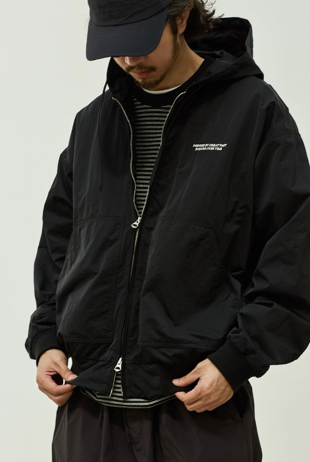 USAGE Crinkle Nylon Hooded Track Jacket in Black - On Male Model