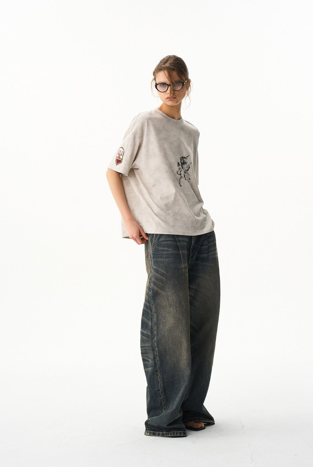 BLINDNOPLAN Wax Print Unicorn Graphic T Shirt in Beige - On Female Model