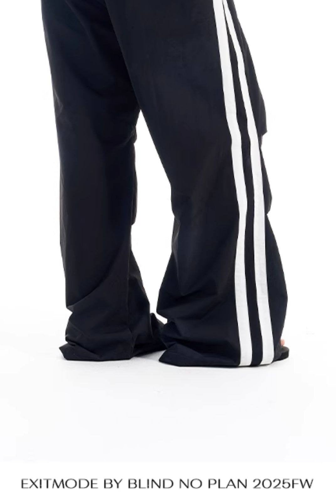 BLINDNOPLAN Striped Pleated Track Pants in Black - On Model