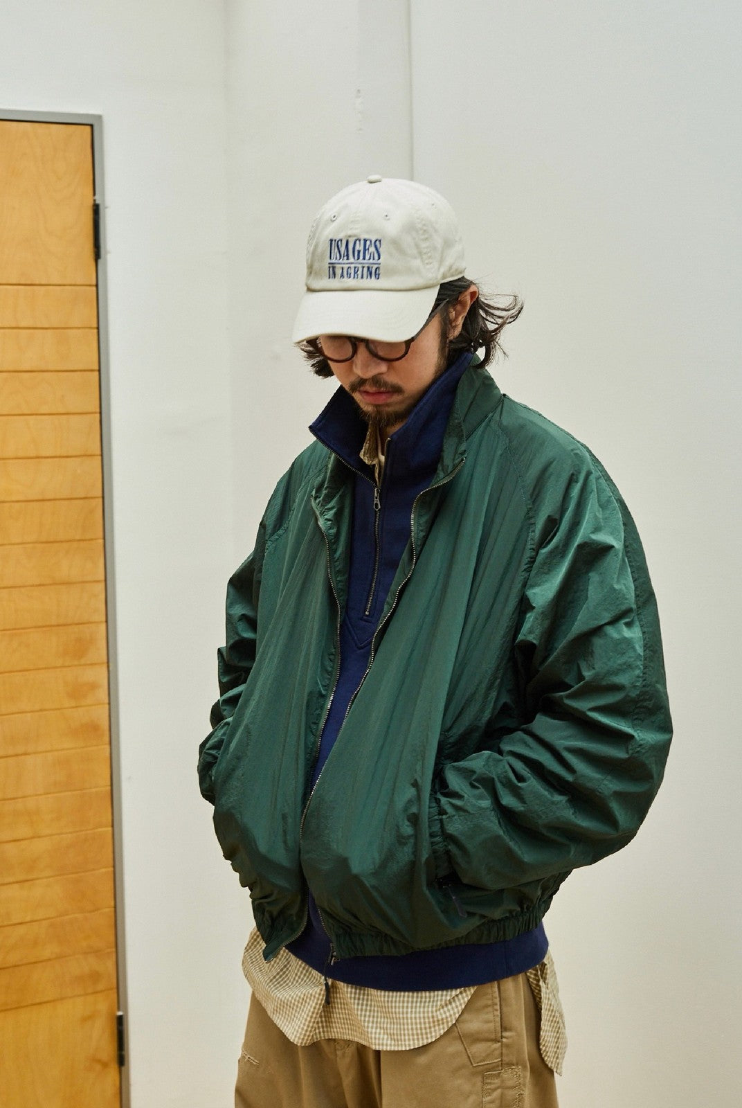 USAGE Lightweight Nylon Zip Up Jacket in Green - On Male Model
