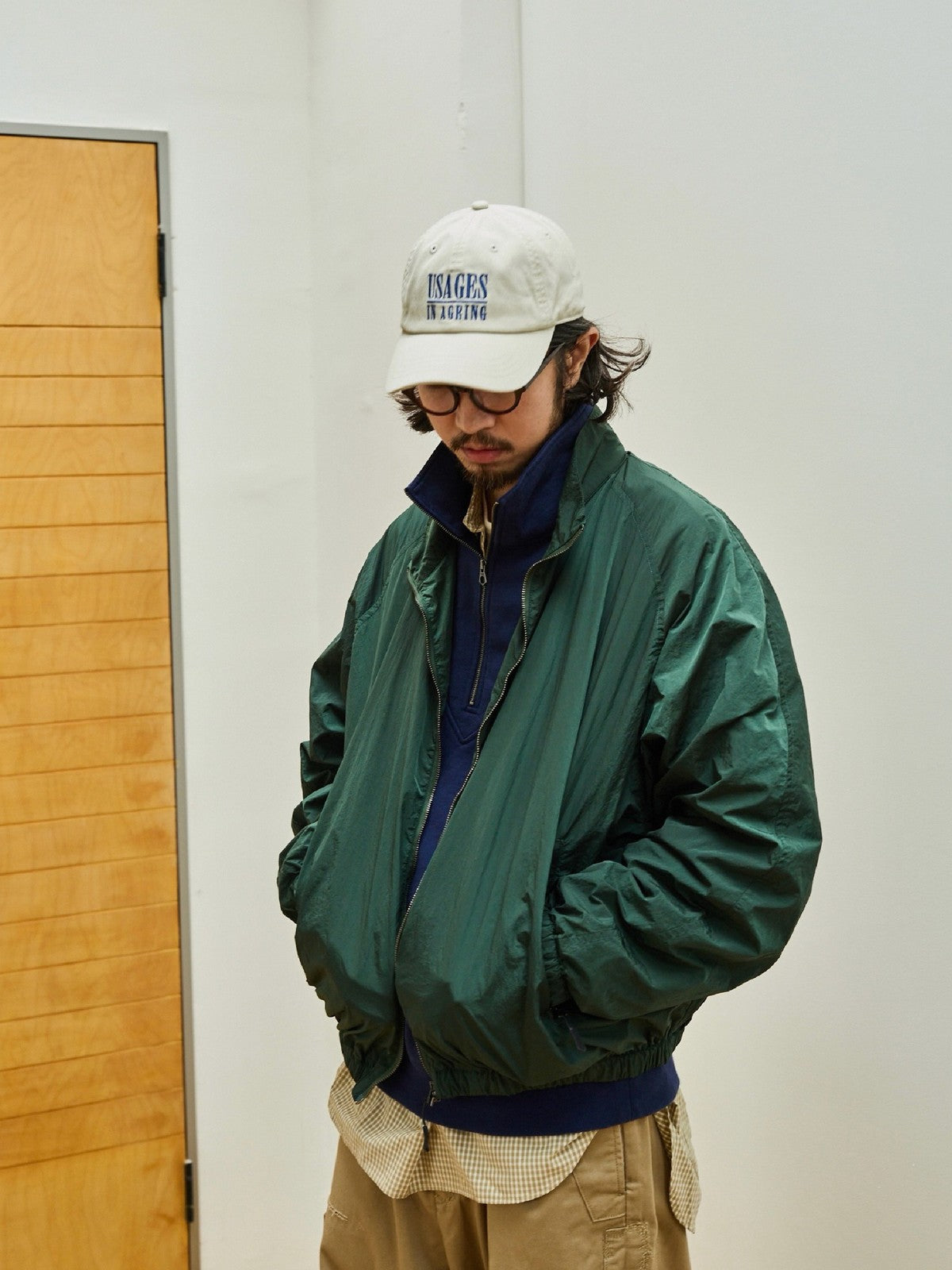USAGE Lightweight Nylon Zip Up Jacket in Green - On Male Model