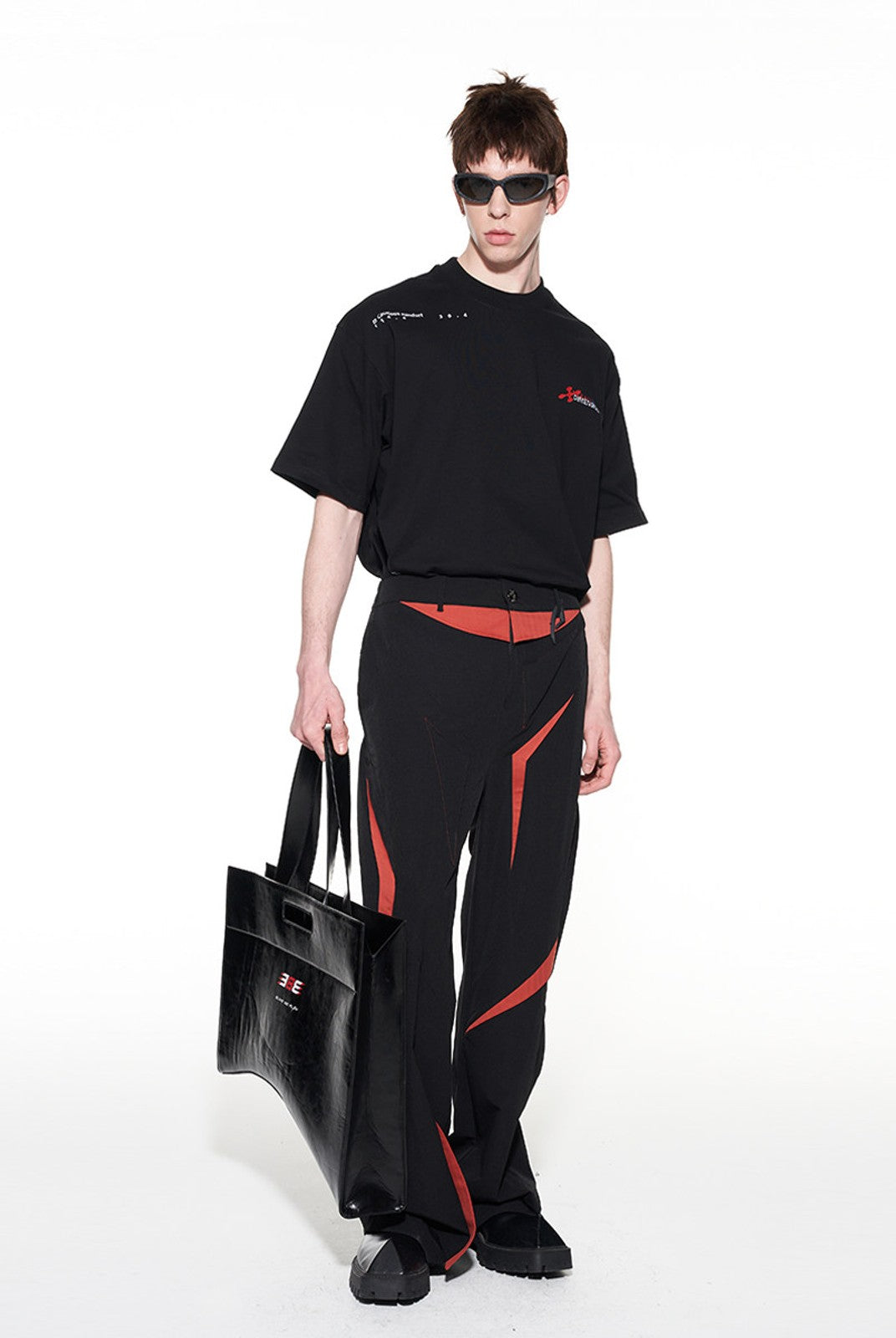 BLINDNOPLAN Textured Faux Leather Asymmetric Tote in Black - On Male Model