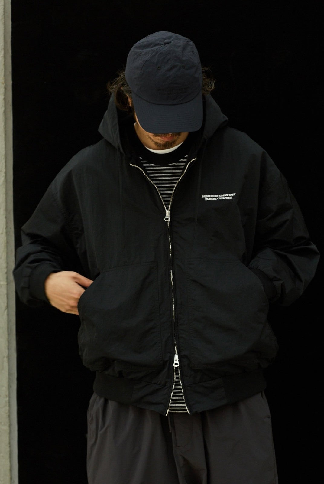 USAGE Crinkle Nylon Hooded Track Jacket in Black - On Male Model