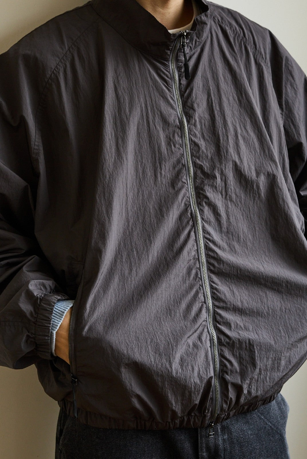 USAGE Lightweight Nylon Zip Up Jacket in Gray - On Male Model