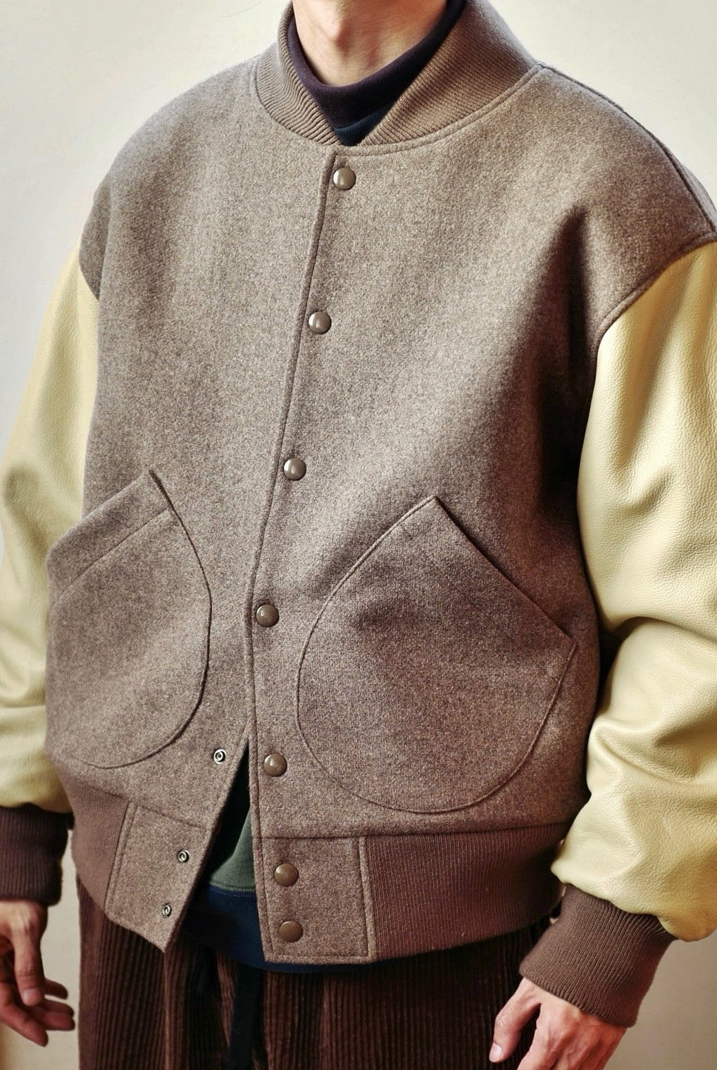 USAGE Reversible Velvet Leather Varsity Jacket in Beige - On Male Model