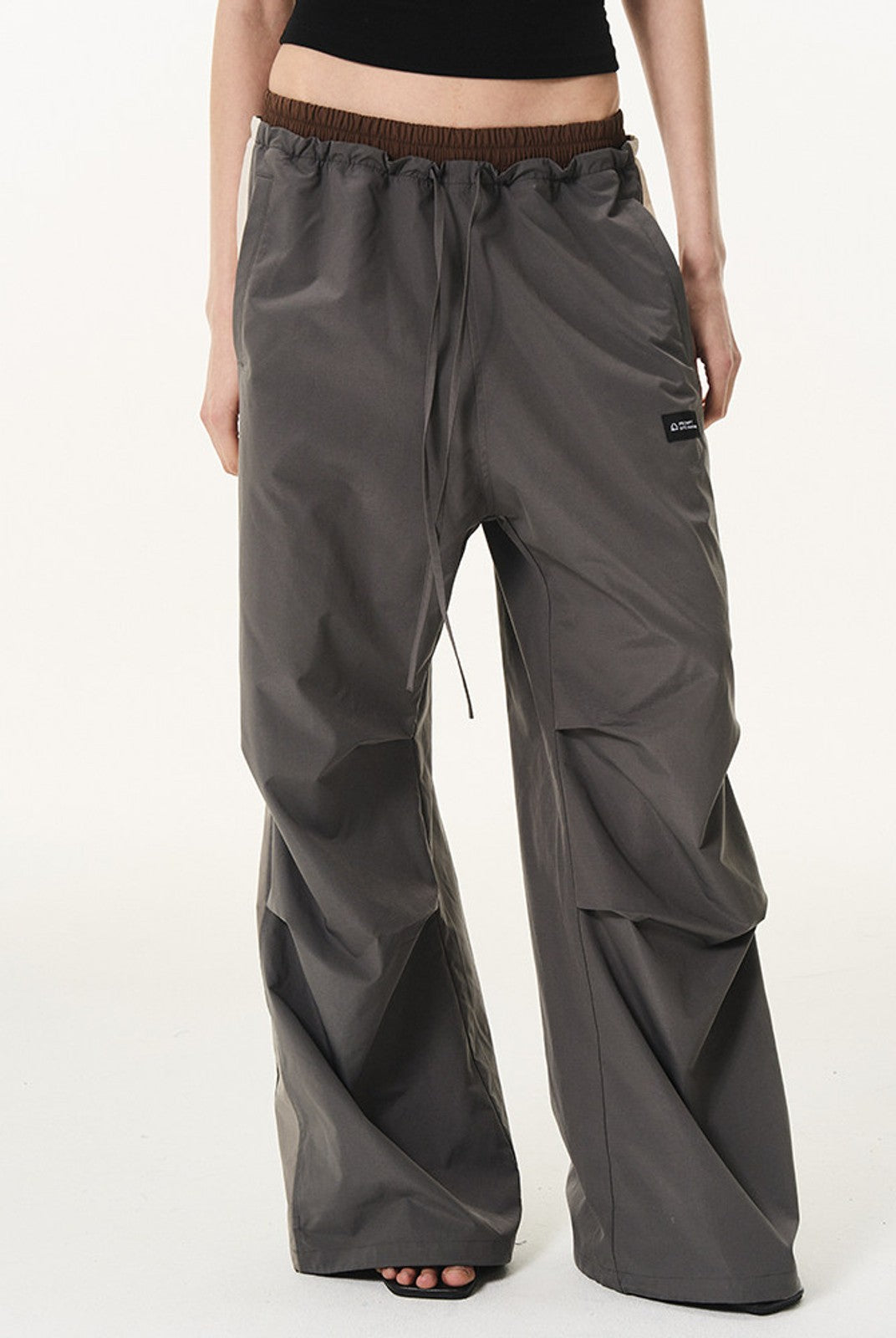 BLINDNOPLAN Contrast Panel Pleated Parachute Pants in Gray - On Female Model
