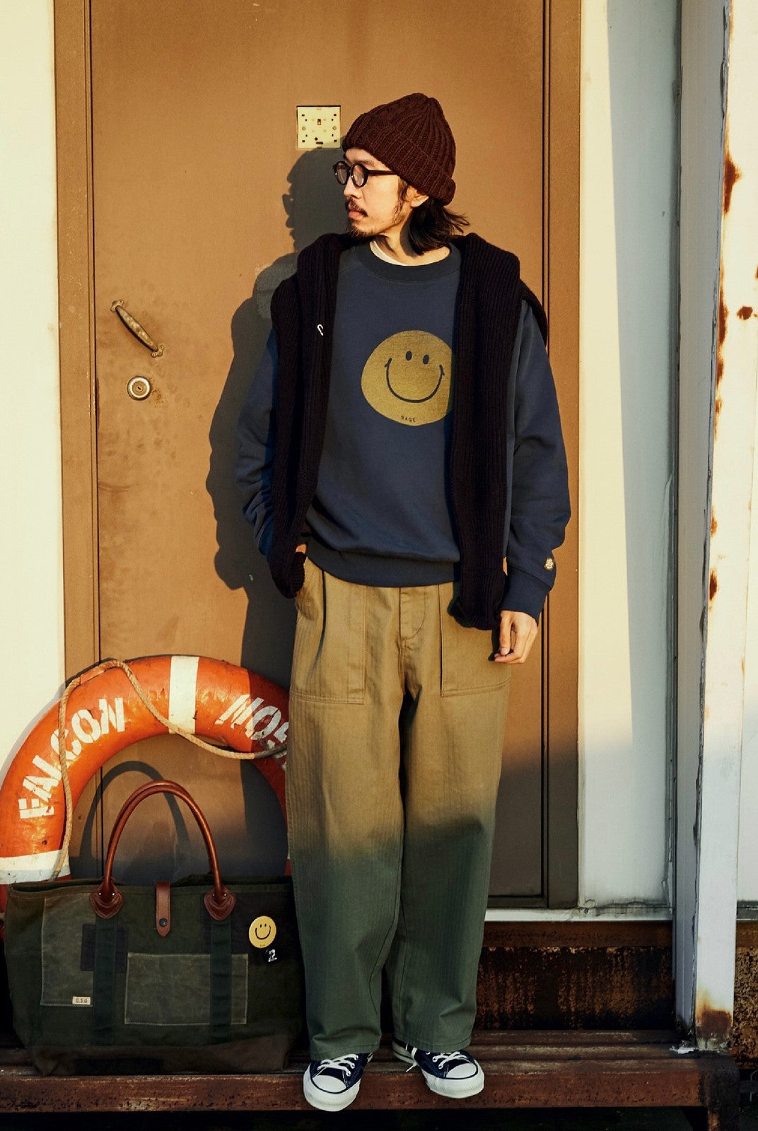 USAGE Washed Cotton Raglan Smiley Sweatshirt in Blue - On Male Model