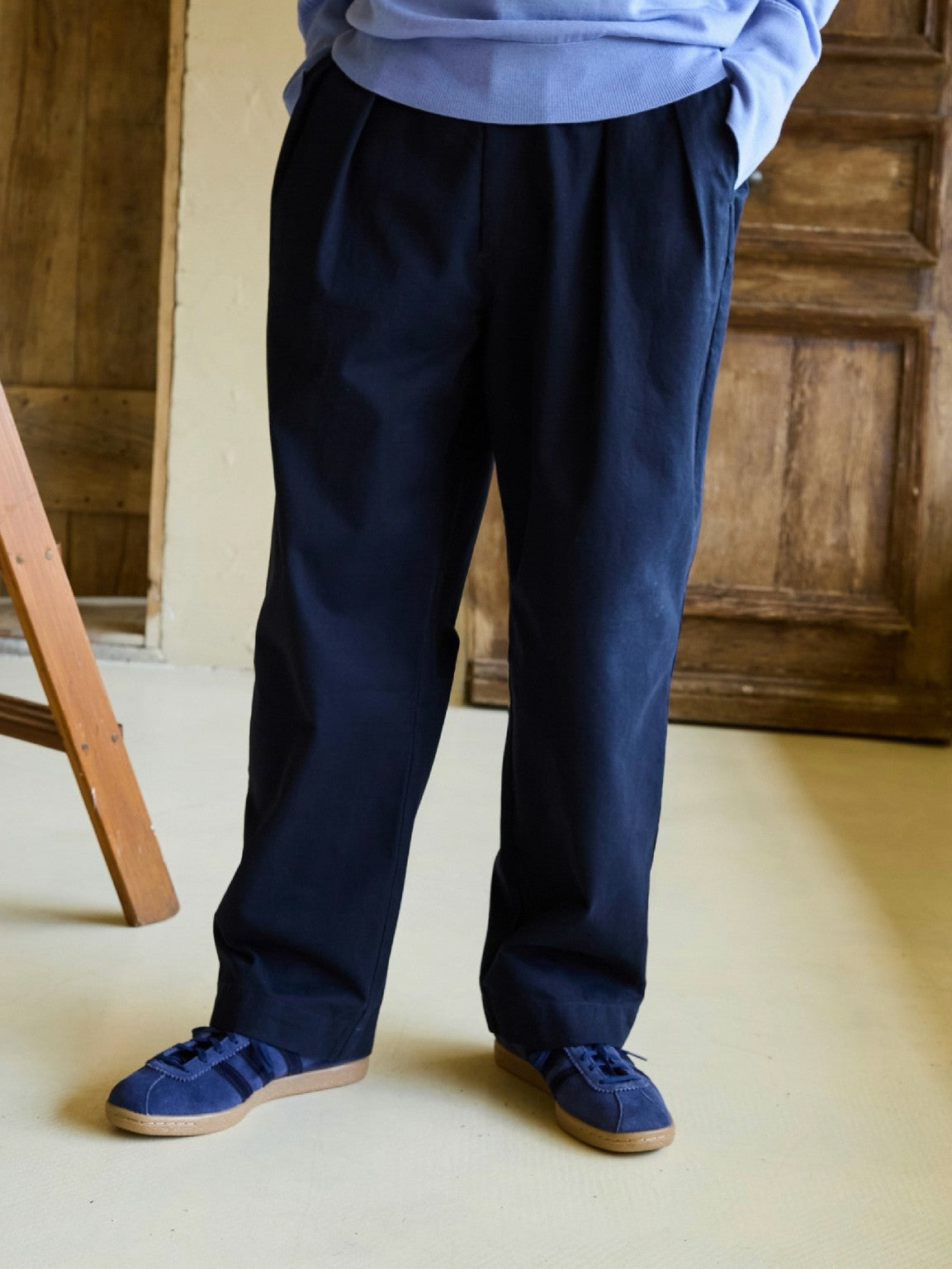 USAGE Pleated Cotton Twill Chinos in Navy Blue - On Model