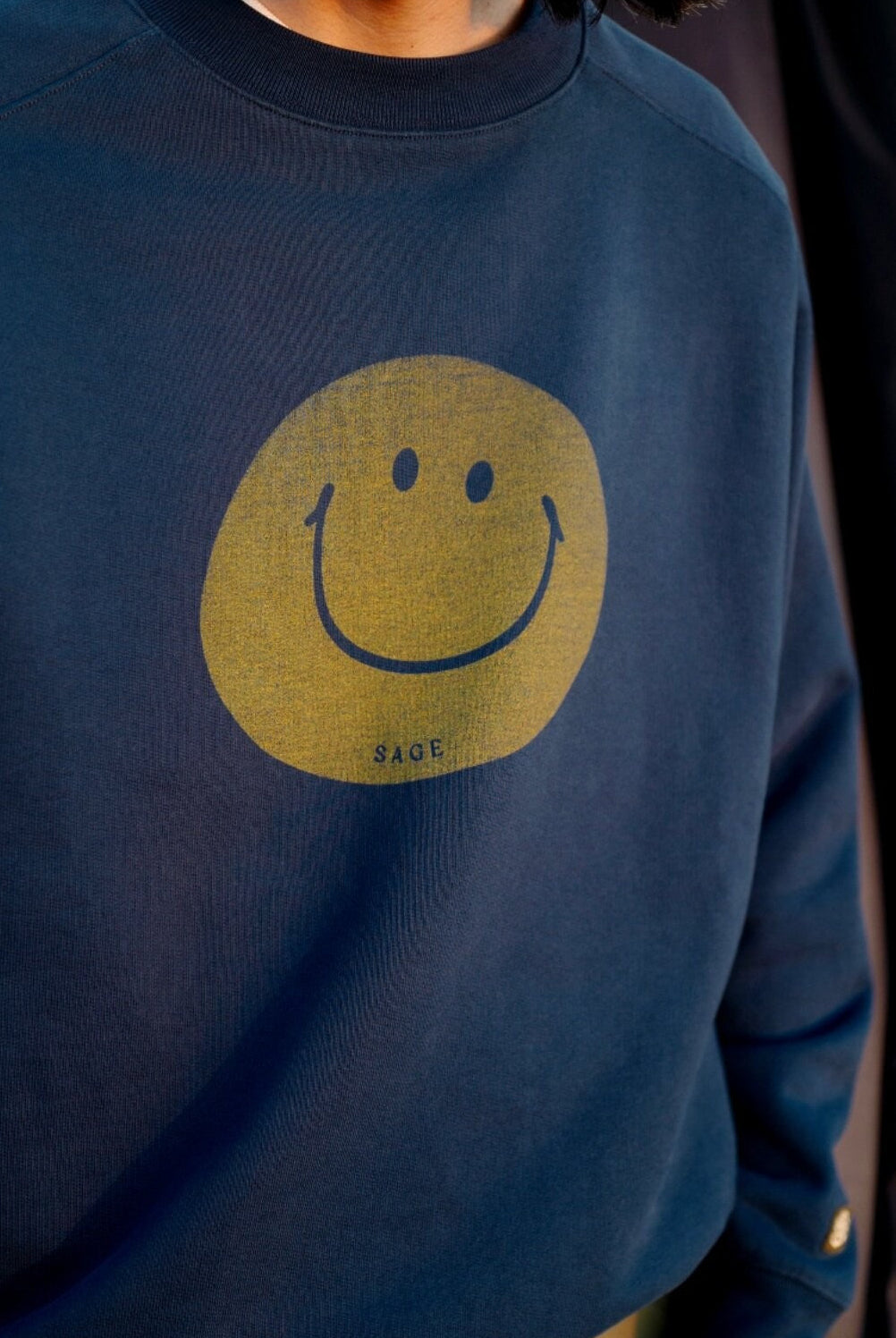 USAGE Washed Cotton Raglan Smiley Sweatshirt in Blue - On Male Model