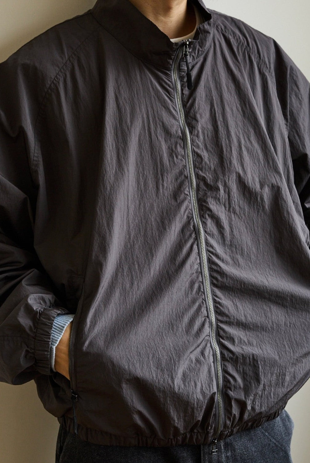 USAGE Lightweight Nylon Zip Up Jacket in Gray - On Male Model