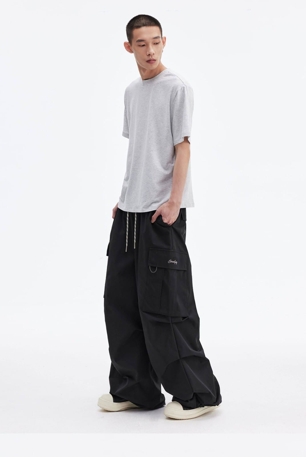 MEDM Multi Pocket Parachute Cargo Pants in Black - On Male Model