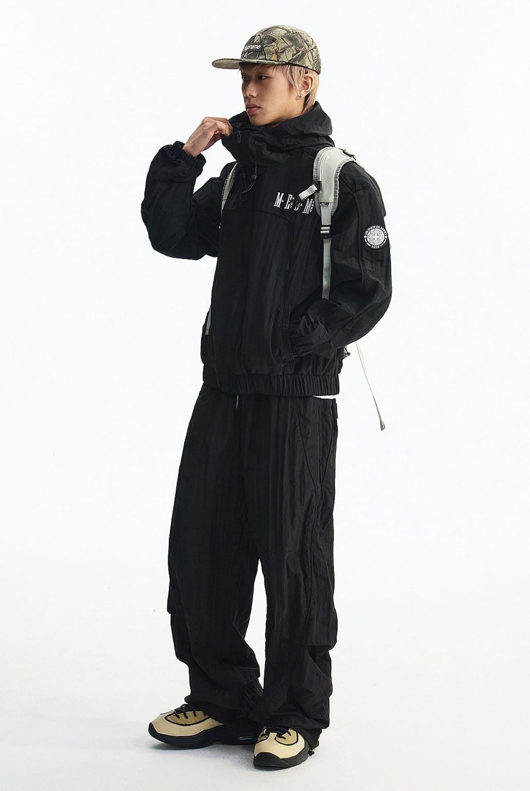 MEDM Glossy Piped Techwear Track Pants in Black - On Male Model
