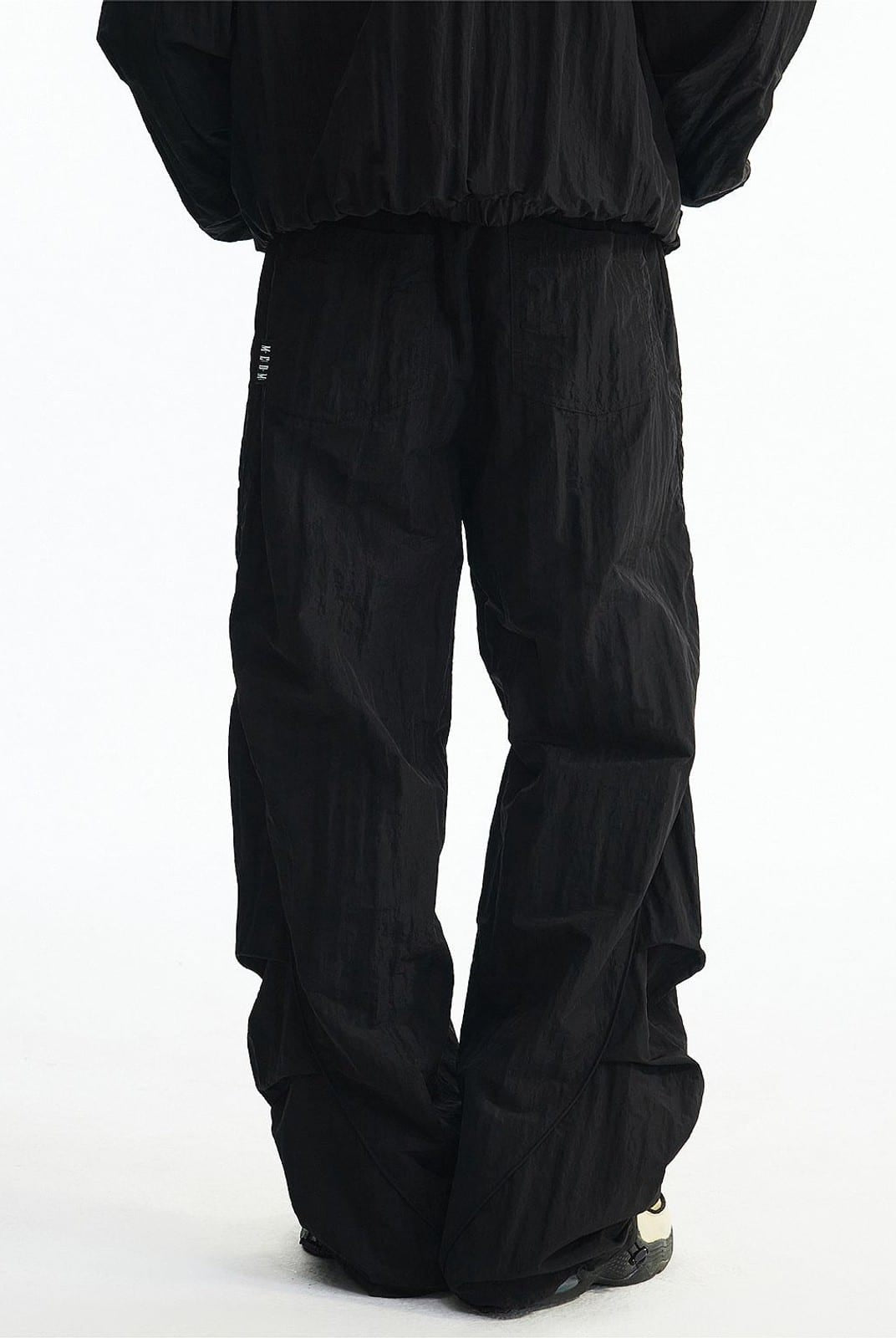 MEDM Glossy Piped Techwear Track Pants in Black - On Model