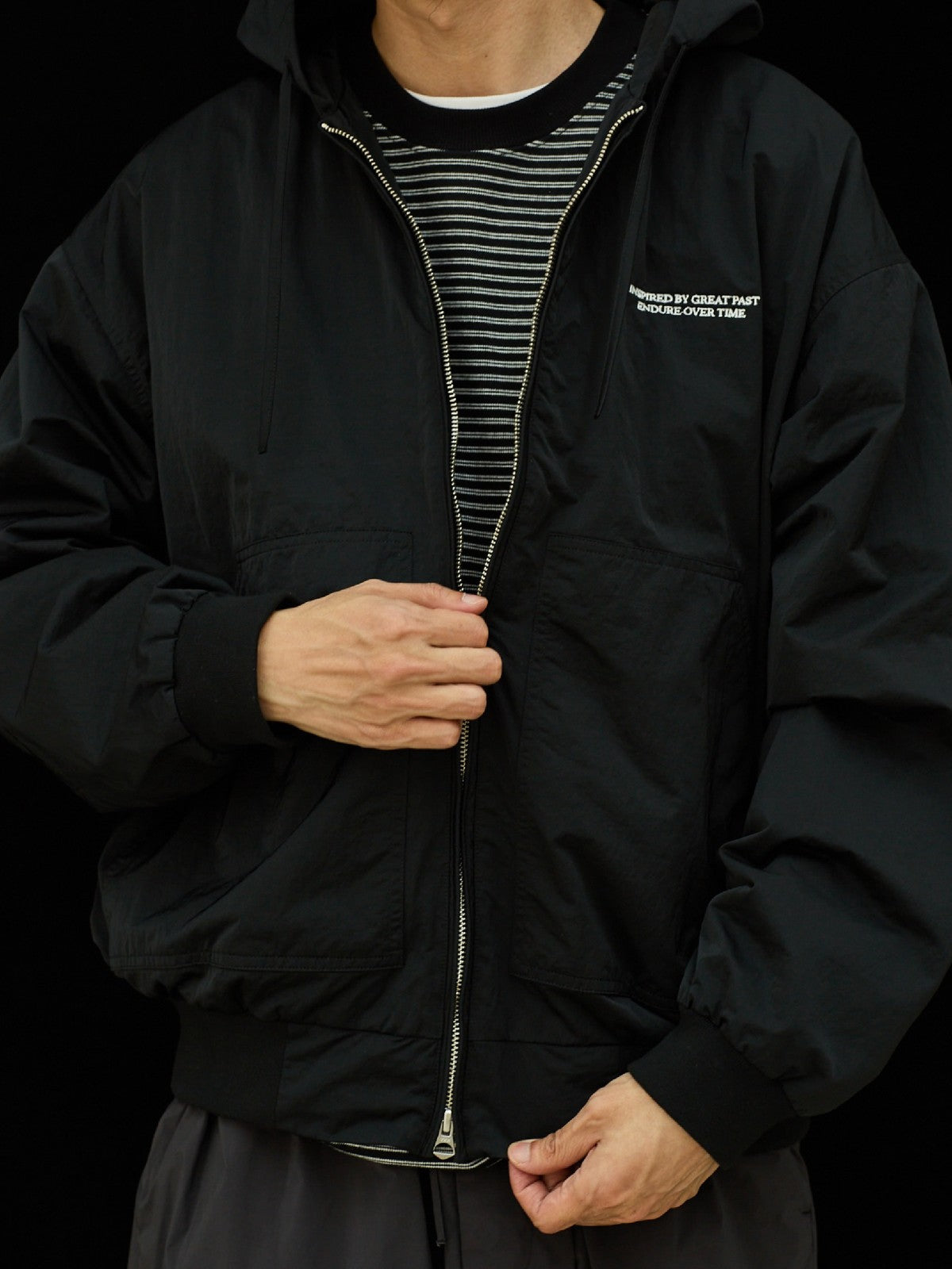 USAGE Crinkle Nylon Hooded Track Jacket in Black - On Male Model
