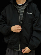 USAGE Crinkle Nylon Hooded Track Jacket in Black - On Male Model