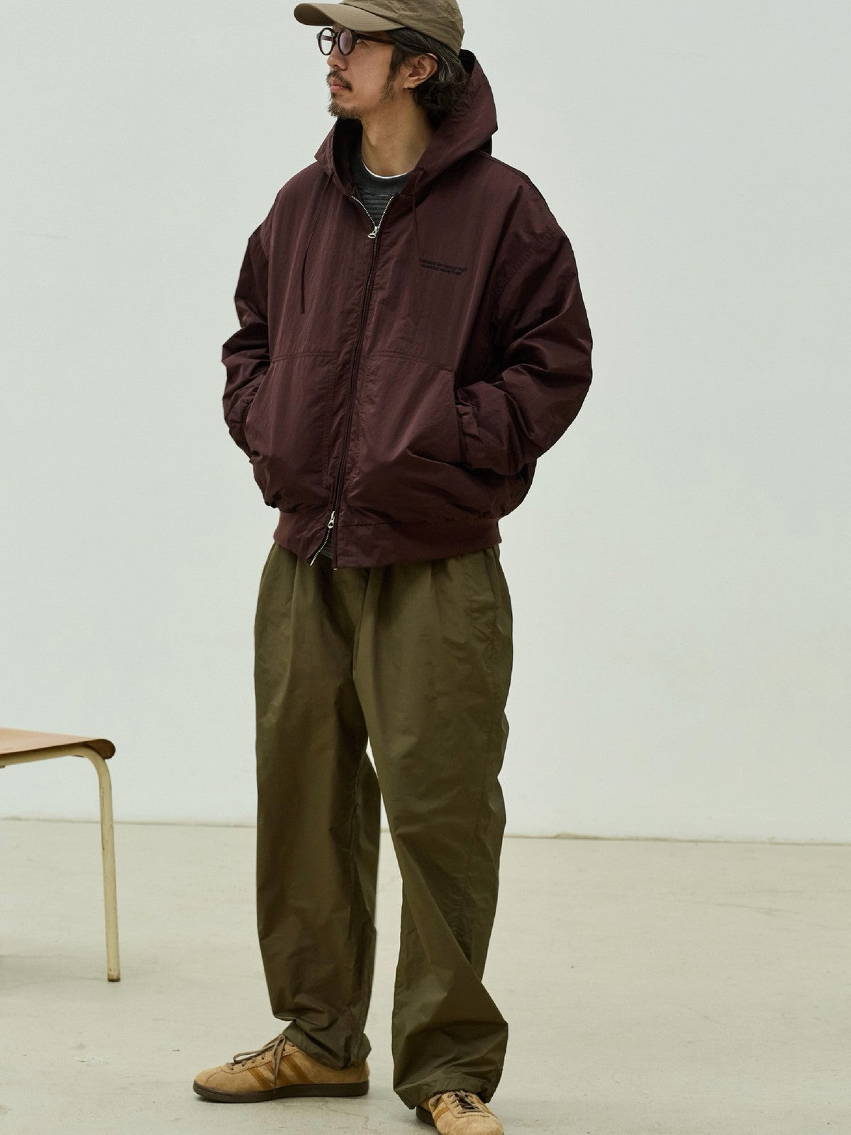 USAGE Crinkle Nylon Hooded Track Jacket in Brown - On Male Model
