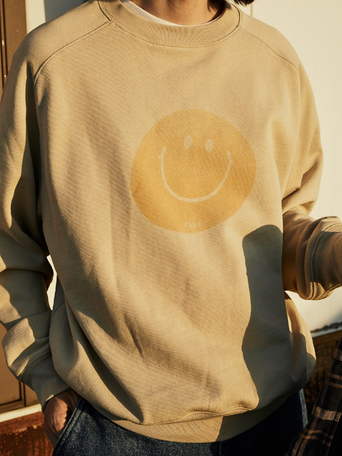 USAGE Washed Cotton Raglan Smiley Sweatshirt in Beige - On Male Model
