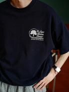 USAGE Retro Tennis Graphic Cotton T Shirt in Navy Blue - On Male Model