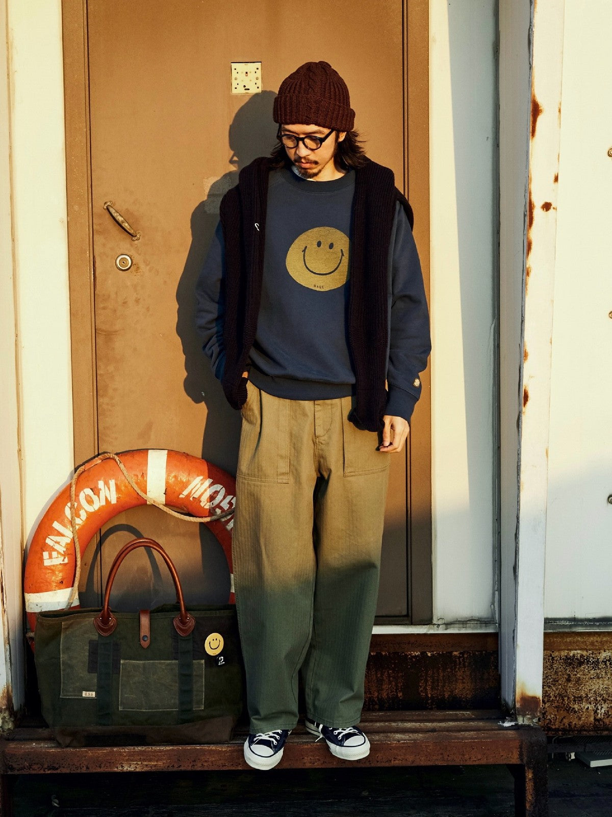 USAGE Washed Cotton Raglan Smiley Sweatshirt in Blue - On Male Model