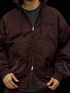 USAGE Crinkle Nylon Hooded Track Jacket in Brown - On Male Model
