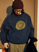 USAGE Washed Cotton Raglan Smiley Sweatshirt in Blue - On Male Model