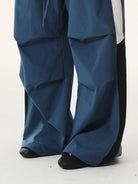 BLINDNOPLAN Contrast Panel Pleated Parachute Pants in Blue - On Model