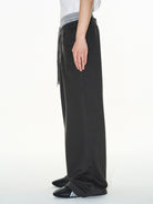 BLINDNOPLAN Double Waistband Pleated Sweatpants in Dark Gray - On Model