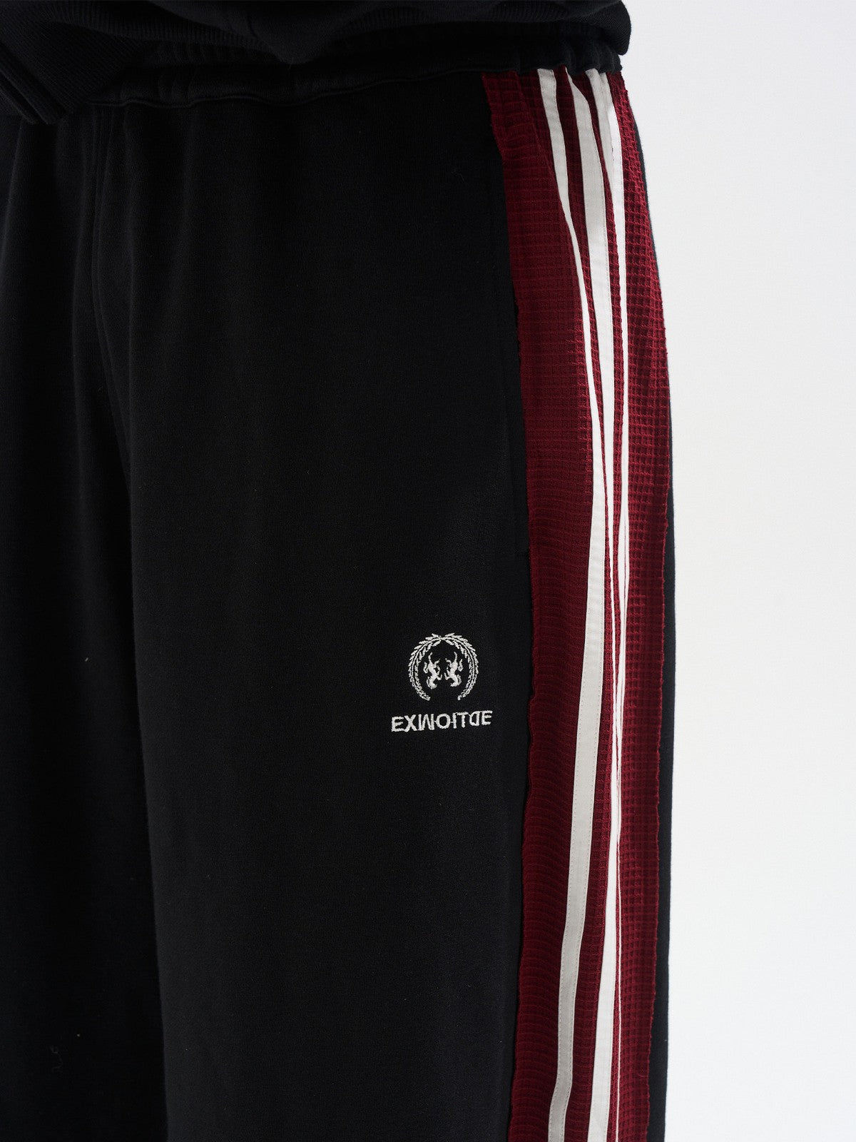 BLINDNOPLAN Raw Edge Contrast Paneled Sweatpants in Black - On Model