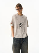 BLINDNOPLAN Wax Print Unicorn Graphic T Shirt in Beige - On Female Model