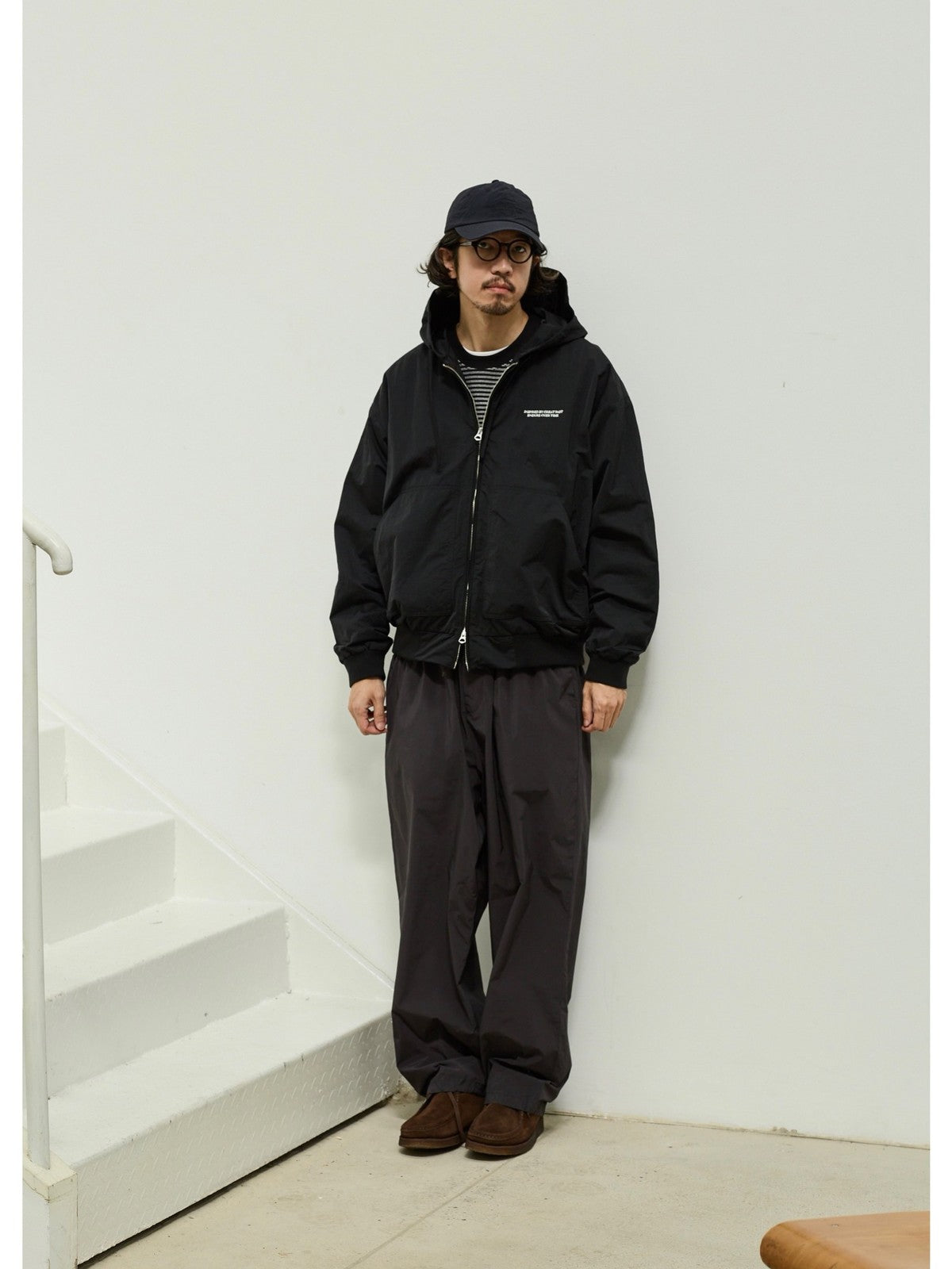 USAGE Crinkle Nylon Hooded Track Jacket in Black - On Male Model