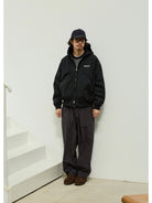 USAGE Crinkle Nylon Hooded Track Jacket in Black - On Male Model