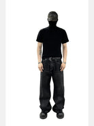 UNKNOWNWORLD Washed Waxed Wide Leg Jeans in Black - On Model