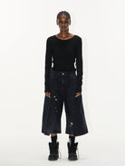 BLINDNOPLAN Ink Splatter Denim Carpenter Shorts in Black - On Female Model
