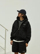USAGE Crinkle Nylon Hooded Track Jacket in Black - On Male Model