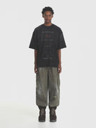 MASONPRINCE Distressed Typographic Cotton T Shirt in Black - On Male Model