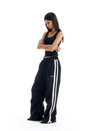 BLINDNOPLAN Striped Pleated Track Pants in Black - On Female Model