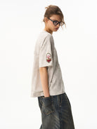BLINDNOPLAN Wax Print Unicorn Graphic T Shirt in Beige - On Female Model