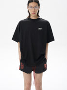 MASONPRINCE Exposed Seam Tape Print T Shirt in Black - On Male Model