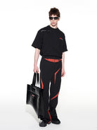 BLINDNOPLAN Textured Faux Leather Asymmetric Tote in Black - On Male Model