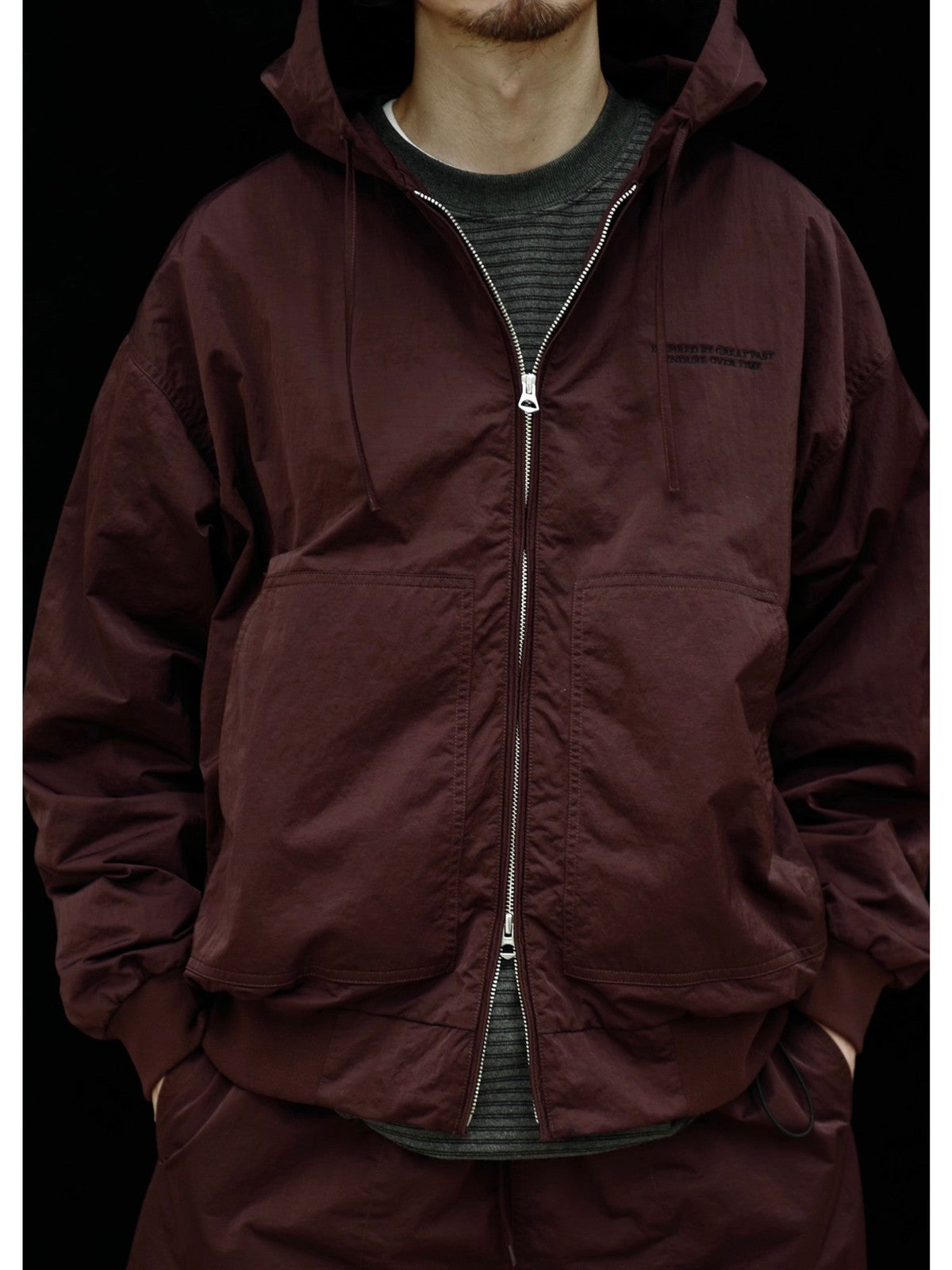 USAGE Crinkle Nylon Hooded Track Jacket in Brown - On Male Model