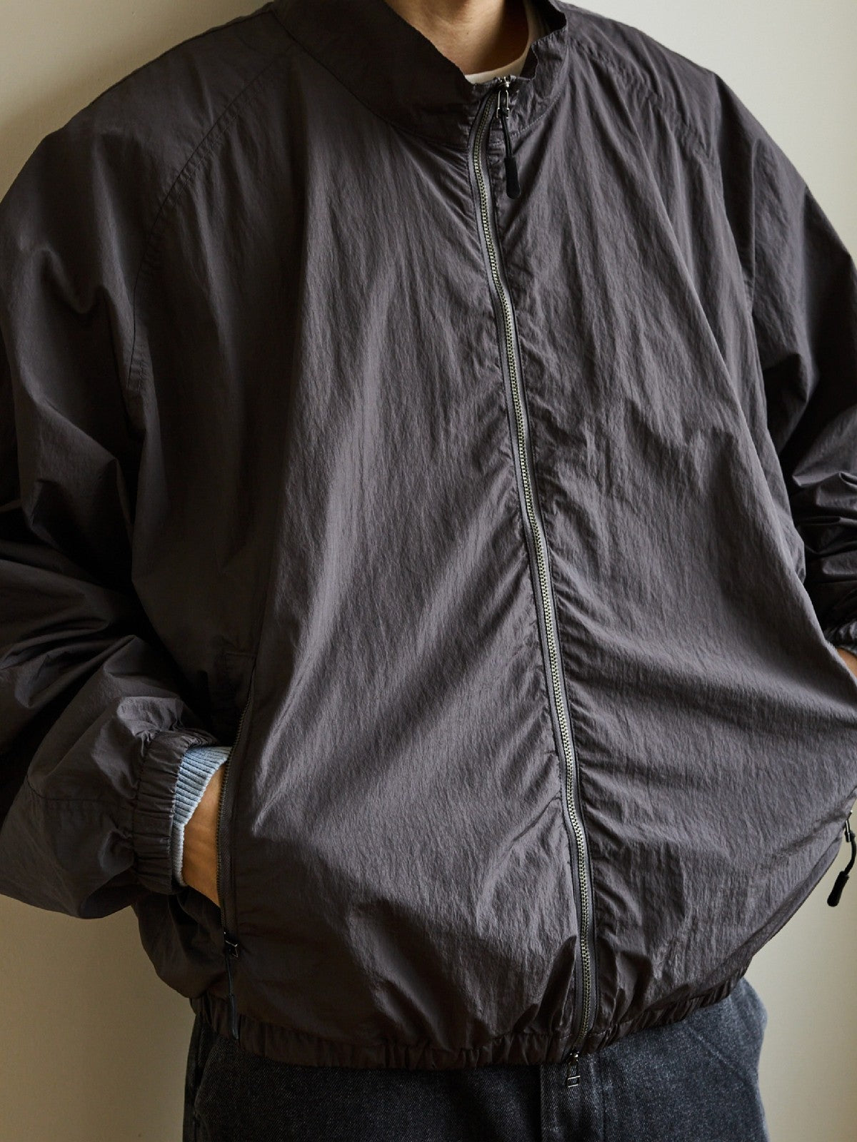 USAGE Lightweight Nylon Zip Up Jacket in Gray - On Male Model